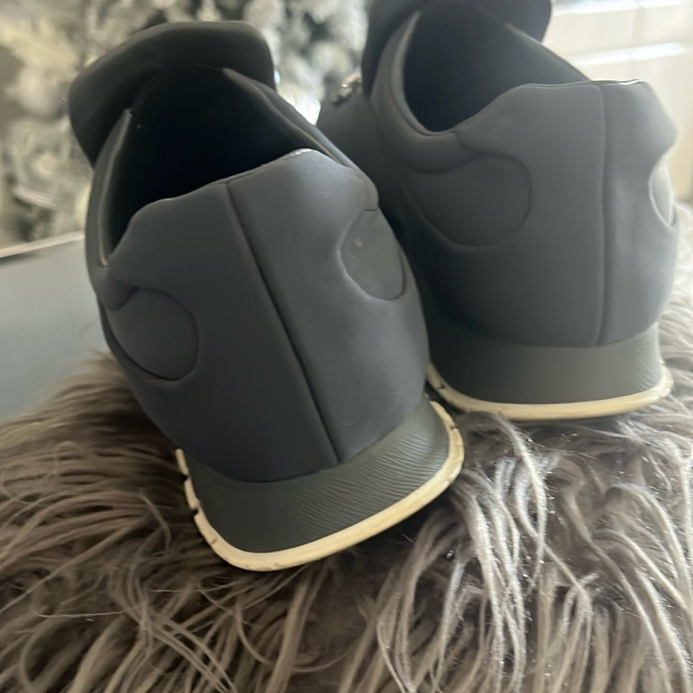 Prada crystal embellished slip on nylon sneakers with leather inside .